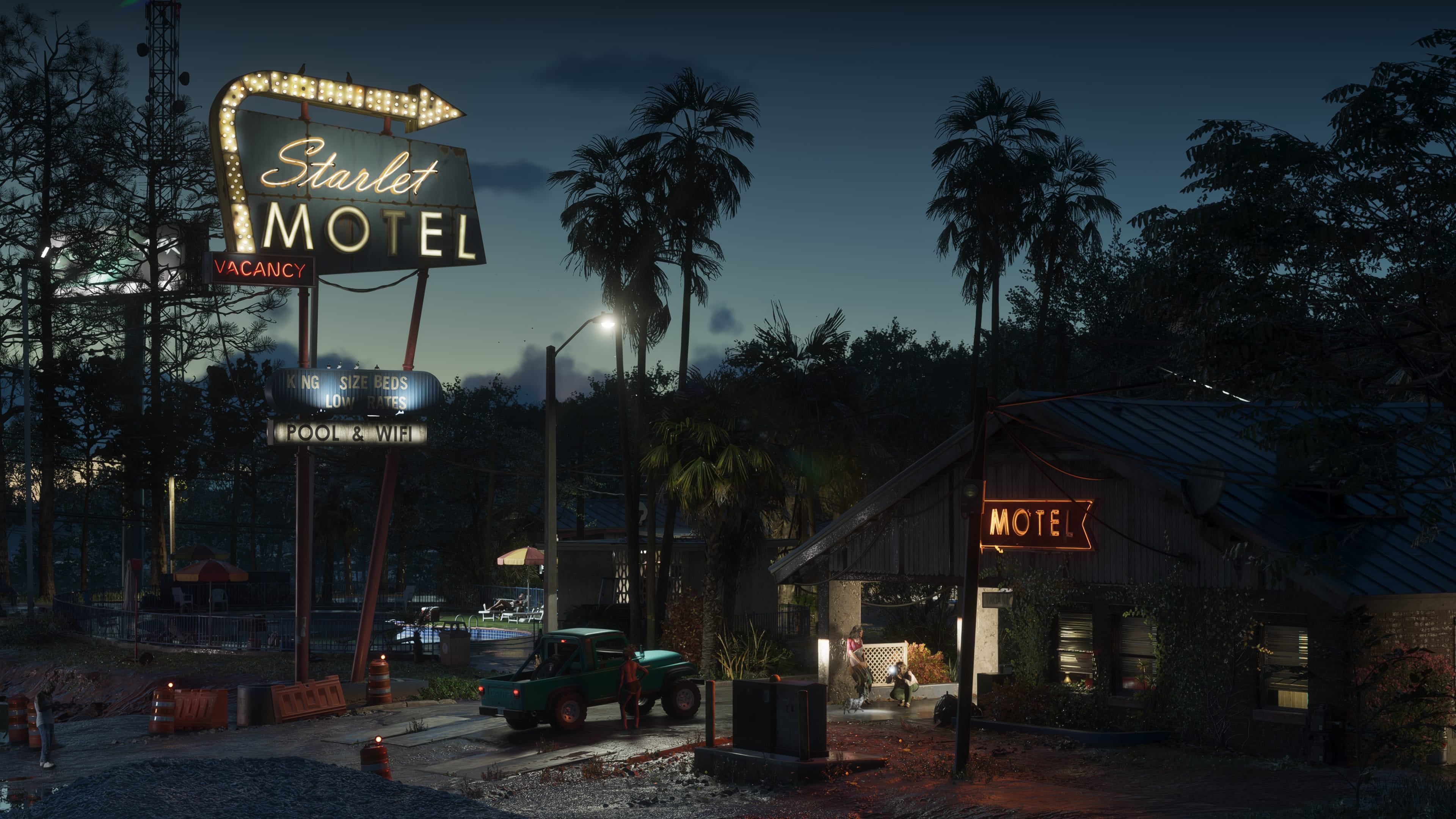 Official GTA VI image of the illuminated Starlet Motel sign and roadside buildings in Port Gellhorn at night