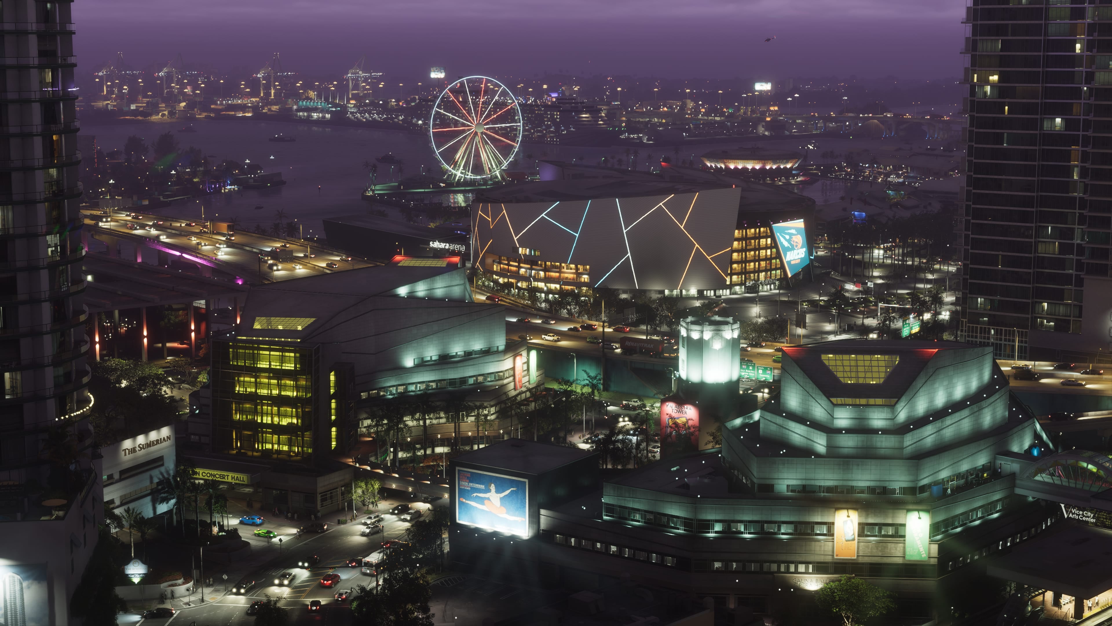 Official GTA VI image of Vice City at night, with the Vice City Arts Center in the foreground and a Ferris wheel on the waterfront.