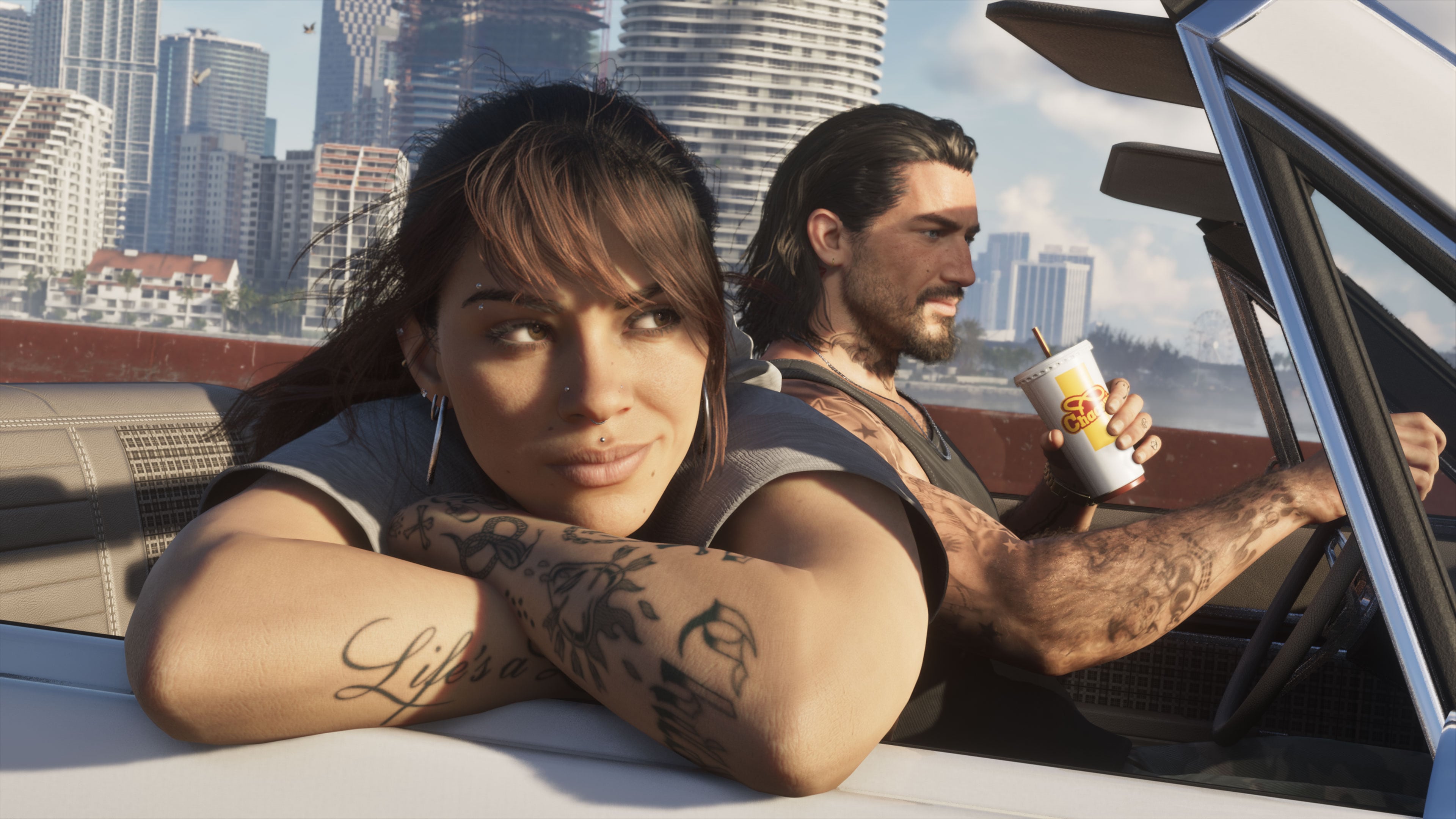 Official Grand Theft Auto VI image of Lucia and Jason in a convertible with Vice City behind them.